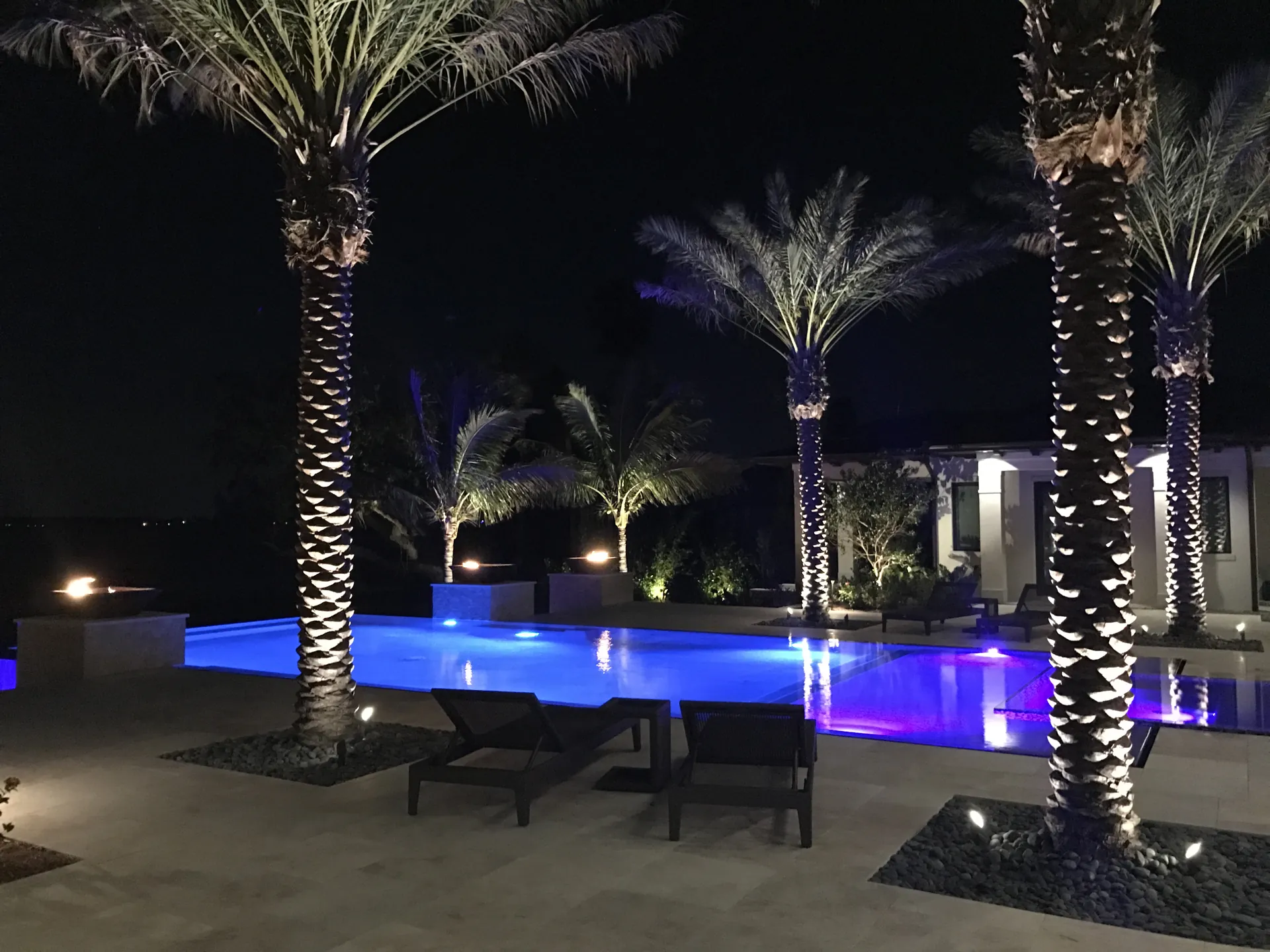 Home 5 Large geometric pool glowing blue from LED lighting at night