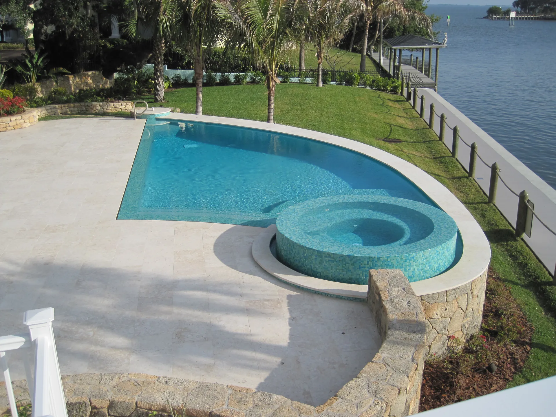 Home 1 Raised glass tile spa on a travertine deck overlooking the Indian River